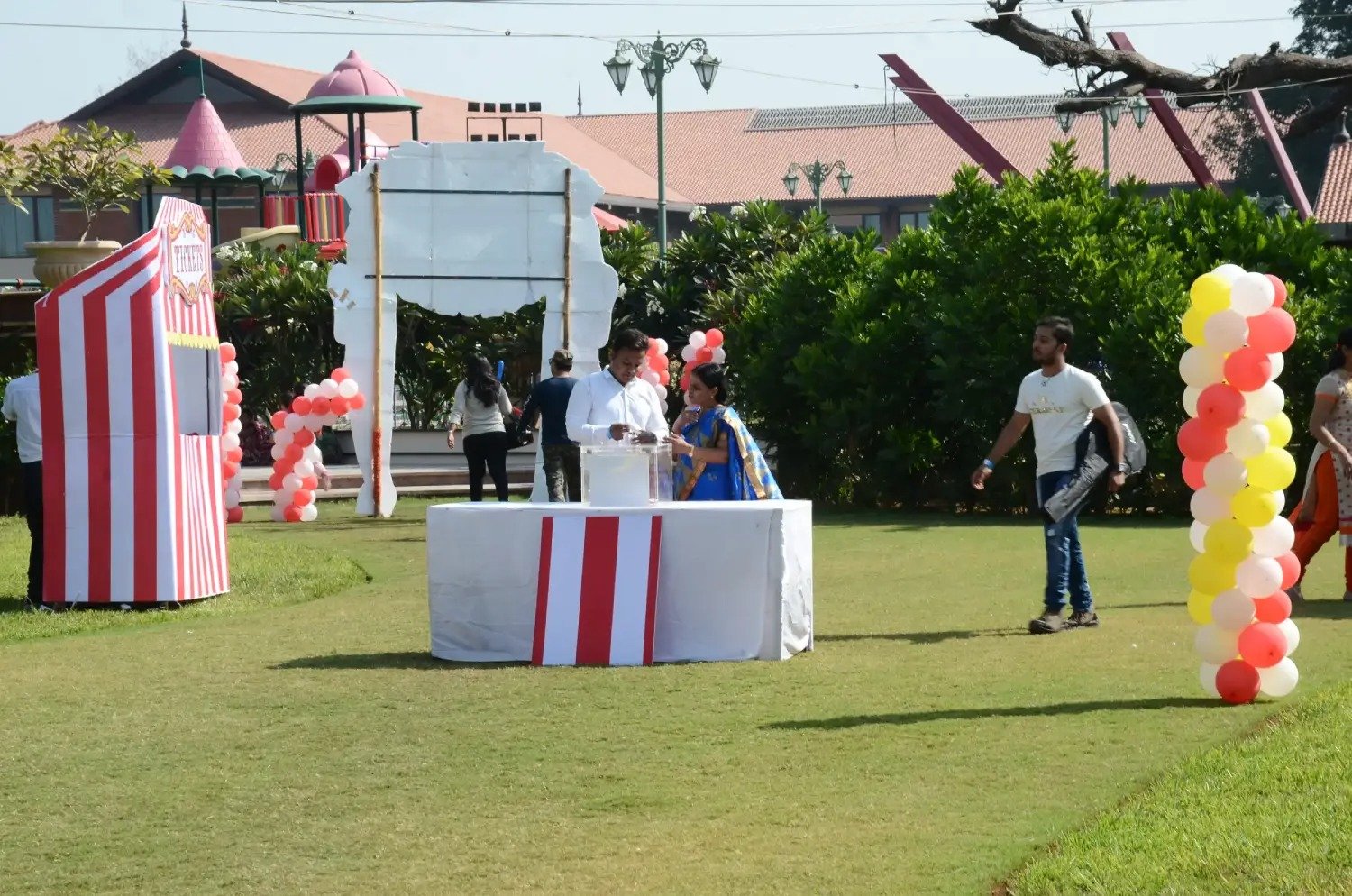 ITT event entrance with red and green carpet and pink lighting on white structure with ITT branding